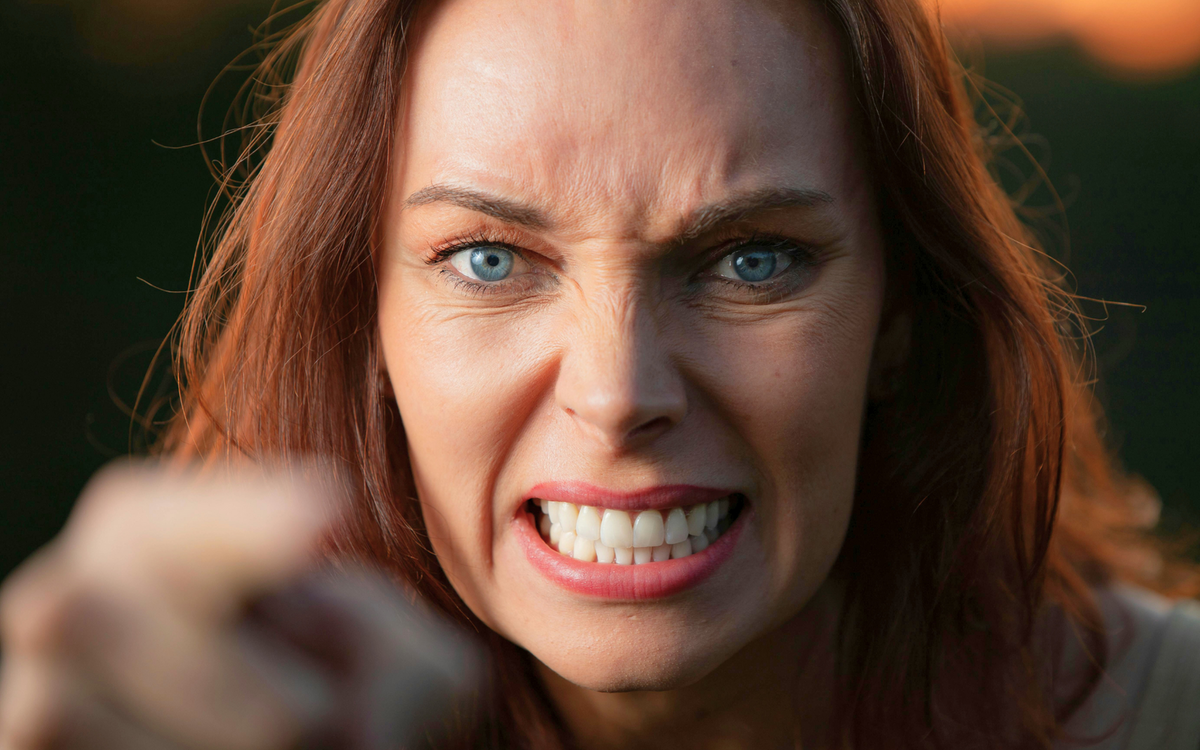 Wütende Frau drückt intentsive Emotionen aus.